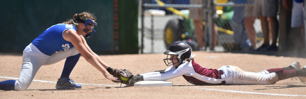 Richmond runner Meranda Martin, right, holds on to third base after over sliding into the bag as Stearns third baseman Maddie Morrison applies the tag during the Class D state championship game Saturday at Coffin Field in Brewer.