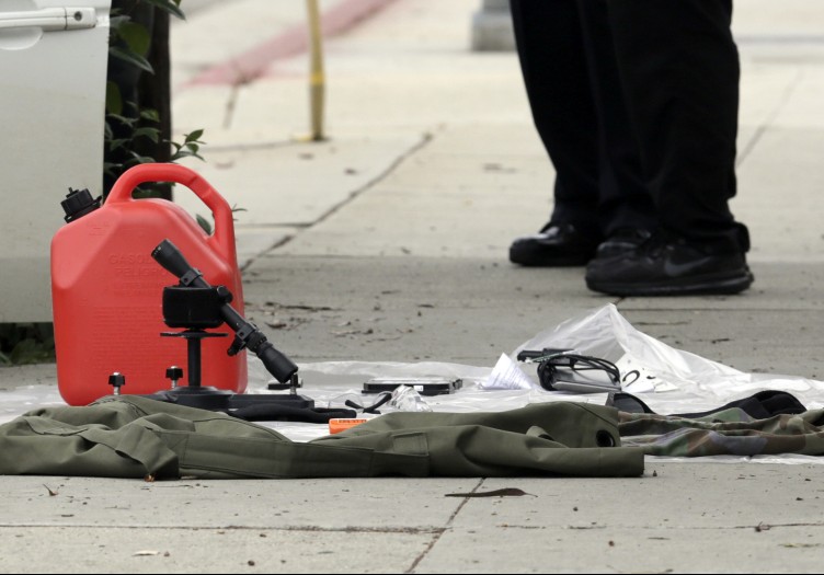 Items removed from a car are displayed on a sidewalk after a heavily armed man was arrested in Santa Monica, Calif., on June 12.