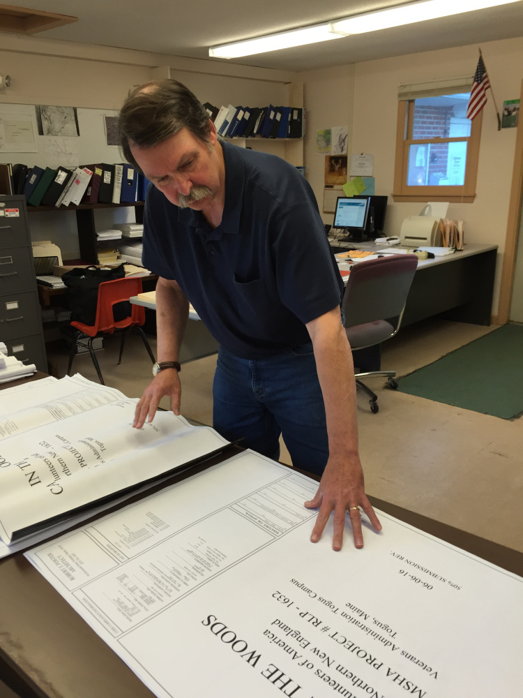 Bill Butler, the code enforcement officer for the town of Chelsea, reviews the plans for the Cabin in the Woods project for homeless veterans.