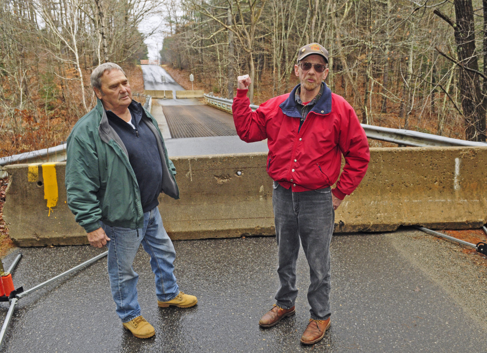 Jerry Brann, left, and Norm Best talk about Northy Bridge in this Dec. 11, 2015, file photo at the bridge on Howe Road in Whitefield. State transportation officials will meet with residents Tuesday to talk about the removal process and the possibility of a footbridge.