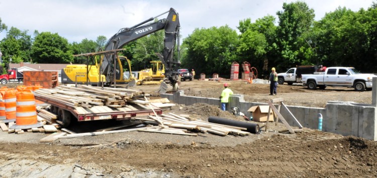 Construction workers build the foundation for the new Newport fire and police departments on Water Street last July. The new public safety building will be dedicated Wednesday.