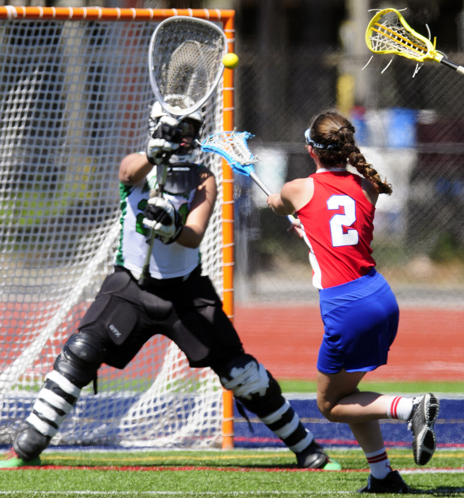 Massabesic goalie Lydia Wasina blocks a shot by Messalonskee's Kailtlyn Smith during the Class A state title game Saturday morning at Fitzpatrick Stadium in Portland.