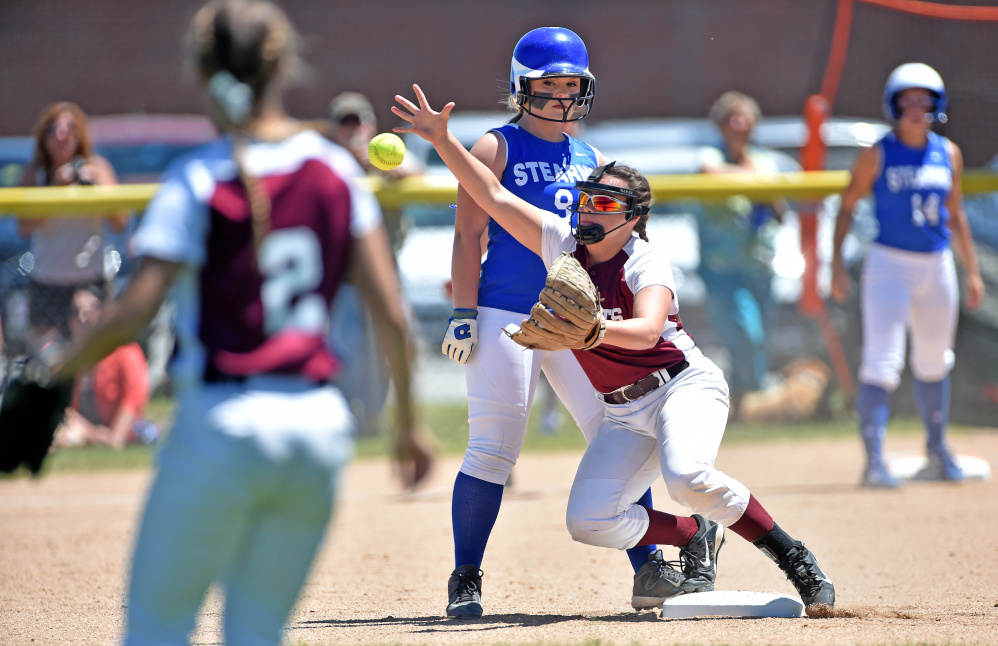 Richmond's Camryn Hurley, middle, tries to field a throw on a hop as Stearns runner Lauren Jamo stands safely on second base during the Class D state championship game Saturday at Coffin Field in Brewer.