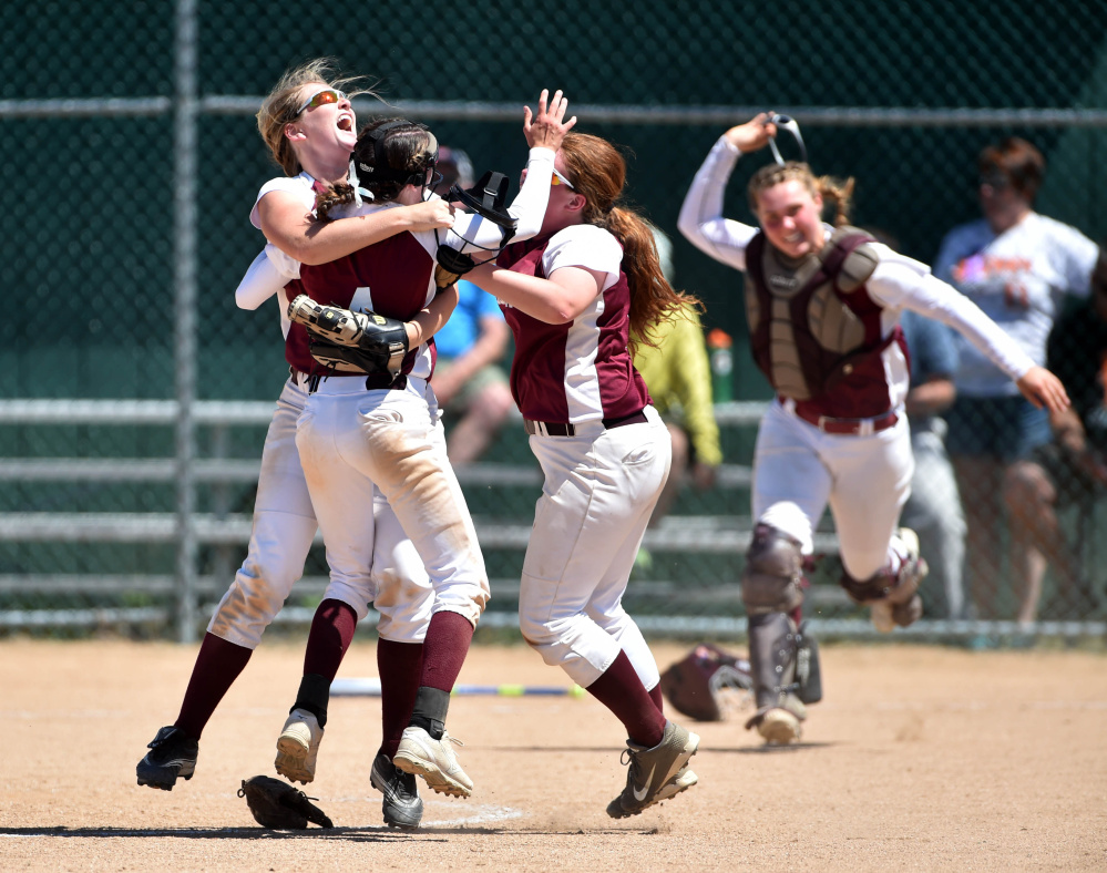 Richmond pitcher Meranda Martin, center, is embraced by teammates after the Bobcats defeated Stearns in the Class D state championship game Saturday at Coffin Field in Brewer.