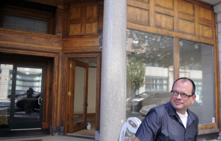 University of Maine at Augusta art professor Peter Precourt stands on Tuesday outside the space he plans to open as a temporary art gallery at 265 Water St. in Augusta.