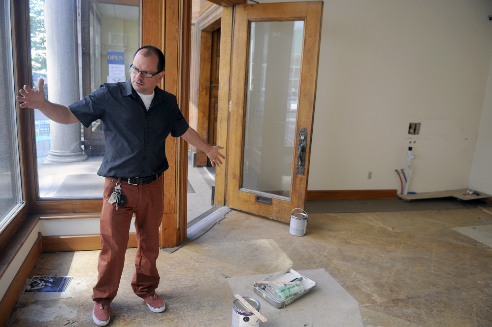 University of Maine at Augusta art professor Peter Precourt discusses on Tuesday the temporary art gallery he plans to open on Water Street in Augusta.