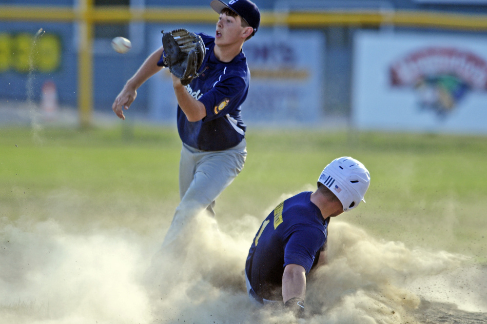 Gardiner second baseman Devon Maschino, left, waits for the throw as Augusta baserunner Cam Brochu slides safely into second base on a stole base attempt during a Zone 2 American Legion game Tuesday night in Augusta.