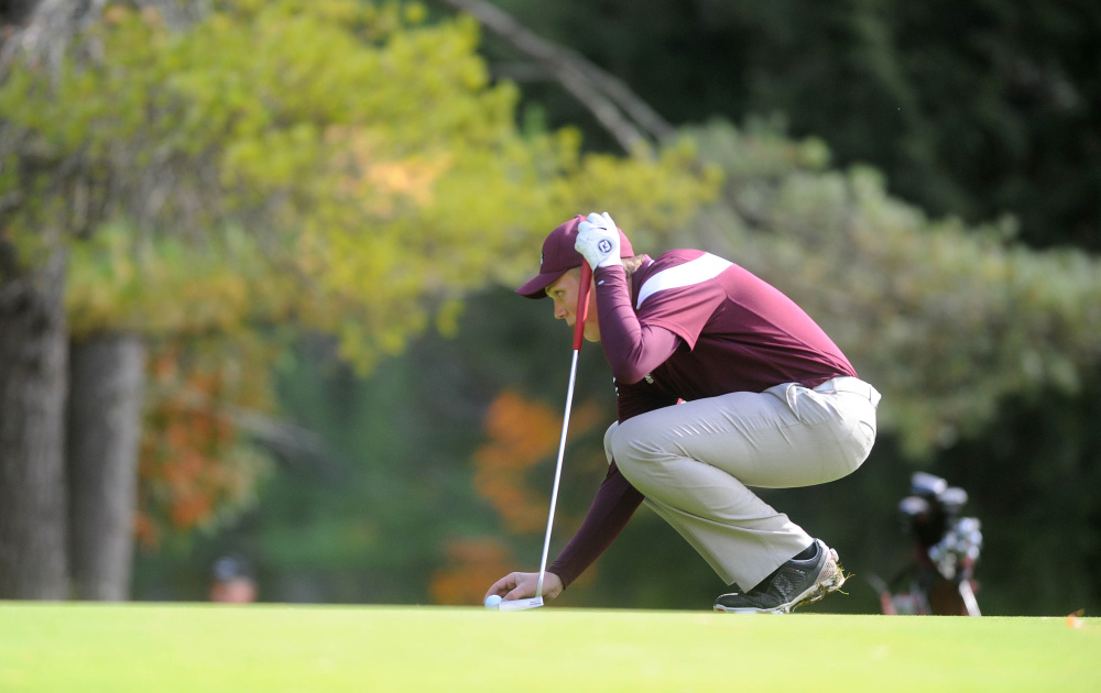 Maine Central Institute's Eric Dugas places his ball on the green as he prepares to putt during the individual state championships last October at Natanis Golf Course in Vassalboro. Dugas, who will be a senior in the fall, tied for second at the New England High School championships in Keene, New Hampshire this week.