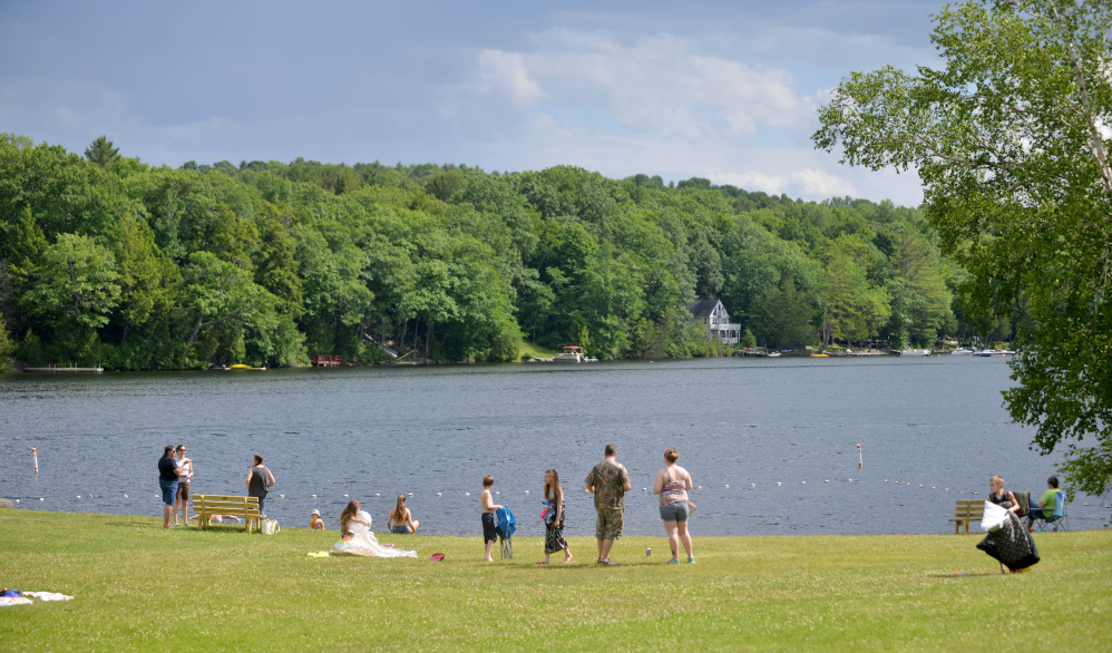 People gather on Thursday at the Oakland town beach on Messalonskee Lake. The town's Gazebo Committee is moving forward with an effort to erect a gazebo there.