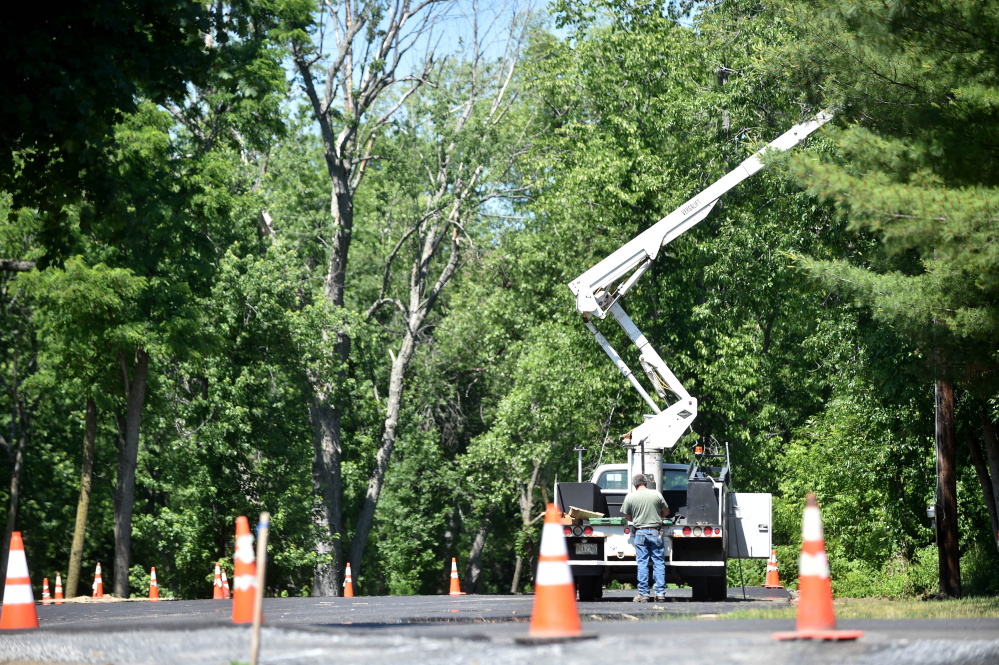 Construction crews work on parking lot lights Friday at the newly built parking area at Fort Halifax Park in Winslow. The construction won't affect next week's Winslow Family 4th of July celebration, Town Manager Michael Heavener said.