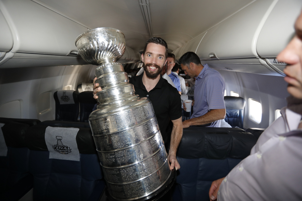 Pittsburgh Penguins video coach Andy Saucier, a 2004 Waterville Senior High School graduarte, holds the Stanley Cup on a plane after the team beat San Jose 3-1 in Game 6 of the finals on June 12.
