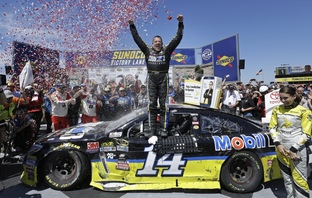 Tony Stewart, center, celebrates after winning the NASCAR Sprint Cup Series race Sunday in Sonoma, California.