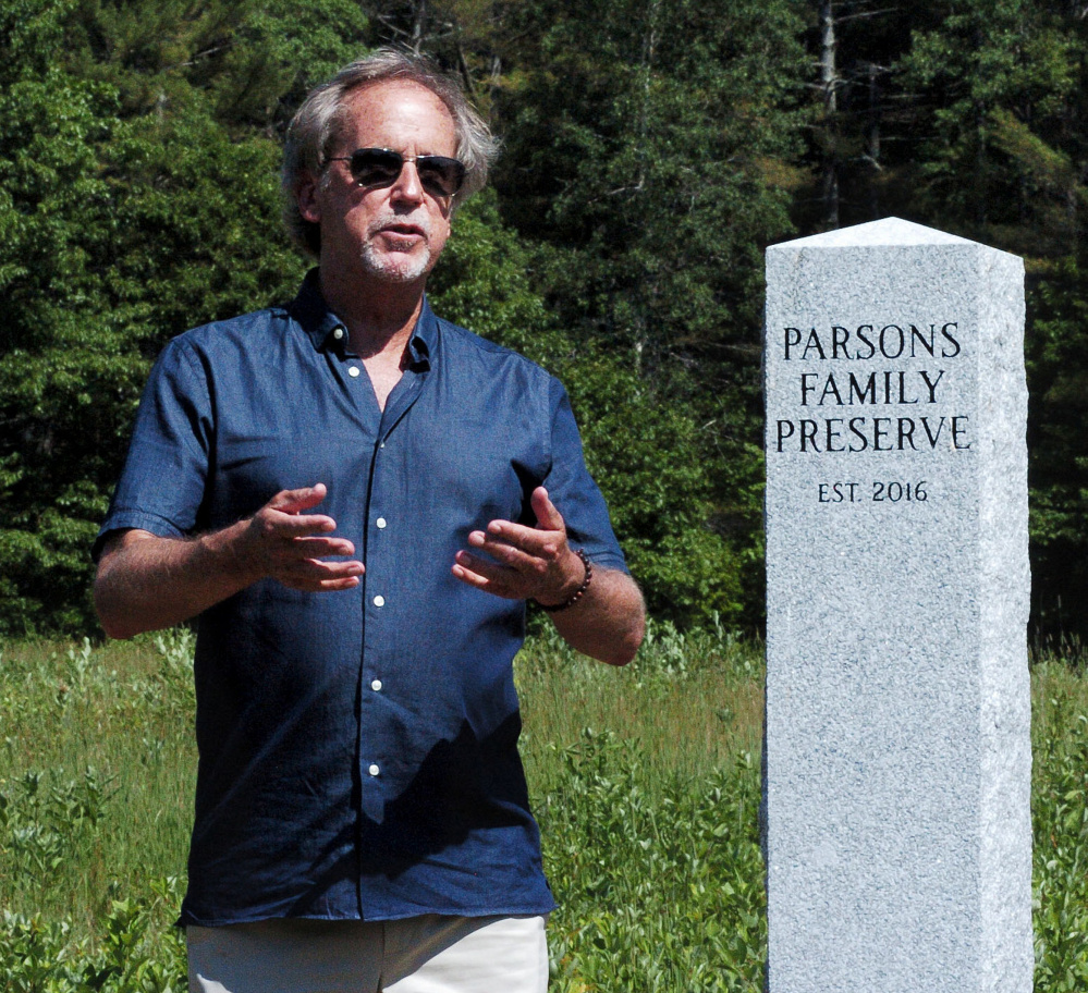 Standing beside a monument marking the Parsons Family Preserve on Sunday, John Parsons speaks about the long history of family-owned land along Malbons Mills Road in Skowhegan. The dedication of the preserve was attended by family members and the Somerset Woods Trustees. The will remain undeveloped and open to the public.