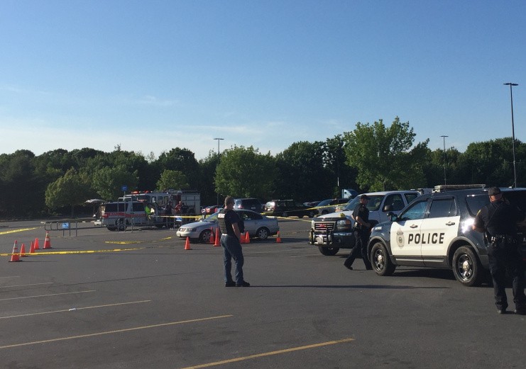 Police work the scene Sunday evening at the Wal-Mart parking lot in Augusta after a fight that resulted in shots being fired.