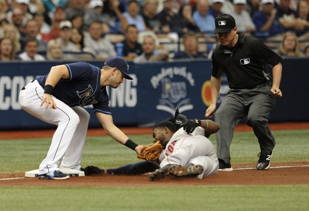 Umpire D.J. Reyburn, right, looks on as Tampa Bay third baseman Evan Longoria, left, tags out Boston baserunner Jackie Bradley Jr. on a stolen base attempt during the fifth inning Wednesday in St. Petersburg, Florida.