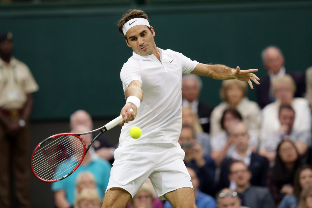 Roger Federer plays a return to Marcus Willis during their singles match on Day 3 of Wimbledon in London on Wednesday.