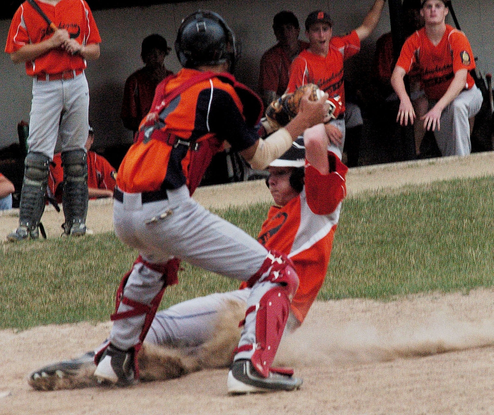 Skowhegan baserunner Tyler Noonan slides into home plate as Messalonskee catcher Percy Carey applies the tag during a junior American Legion game Tuesday at Memorial Field in Skowhegan.