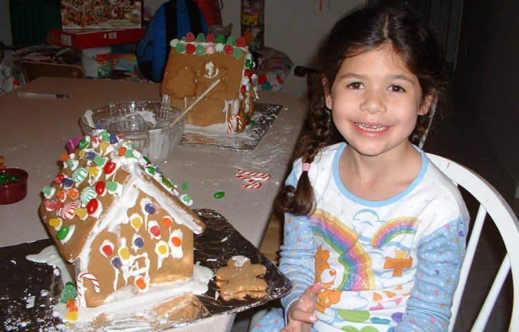 Lucia at 6 years old graduates from constructing graham cracker houses with milk carton centers to store-bought kits made of gingerbread. She starts college this year.