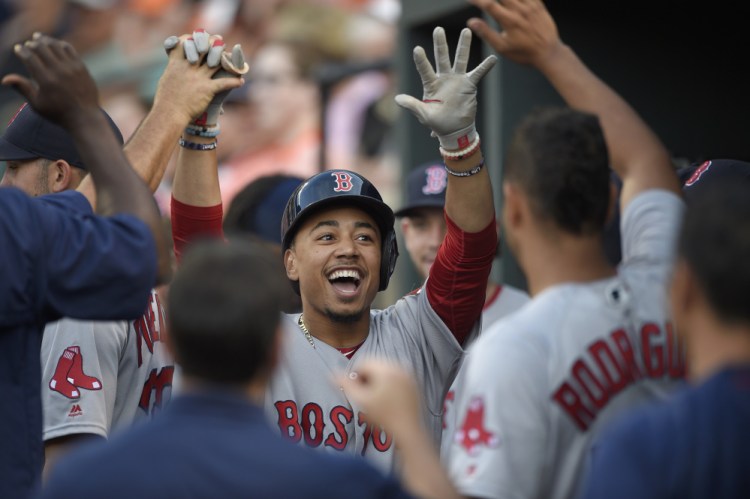 Boston's Mookie Betts celebrates his first-inning home run during the Red Sox's game with Baltimore on Tuesday.   The Associated Press