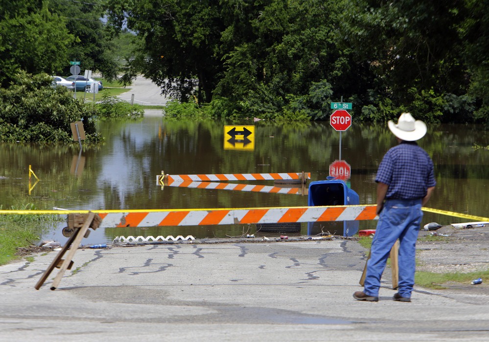 Streets along the Brazos River are closed Thursday in Rosenber, Texas. In Fort Hood, searchers seek four soldiers who are missing after their truck overturned in floodwaters.