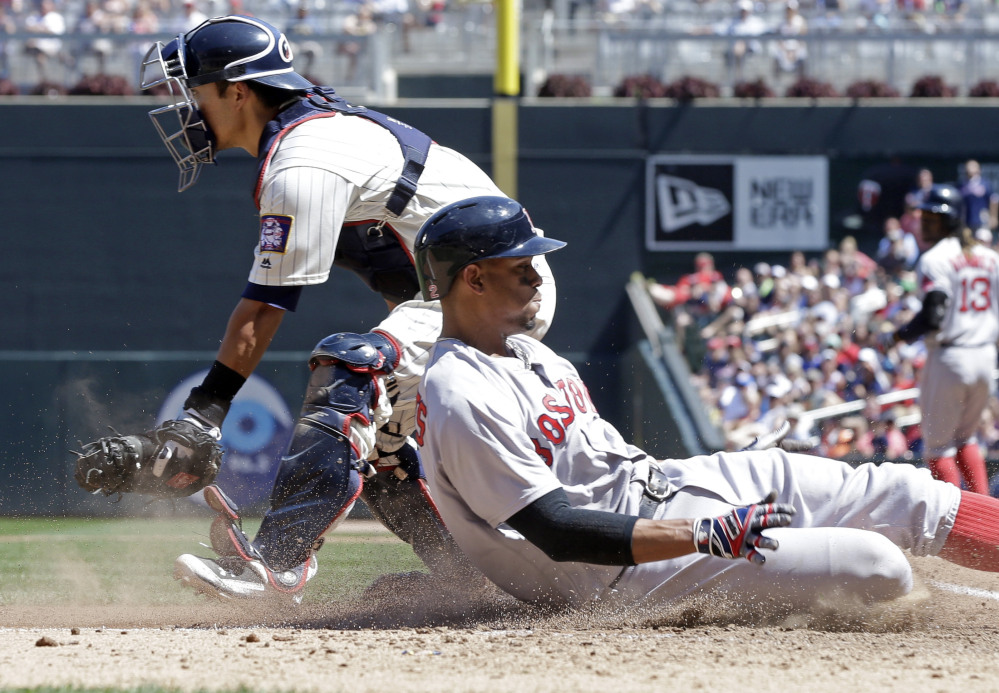 Boston's Xander Bogaerts, right, scores from third on a sacrifice fly by Hanley Ramirez in the sixth inning of the Red Sox' 15-4 win over the Minnesota Twins on Saturday in Minneapolis. Bogaerts was 4 for 5 with a home run, a double, four runs scored and three RBI.