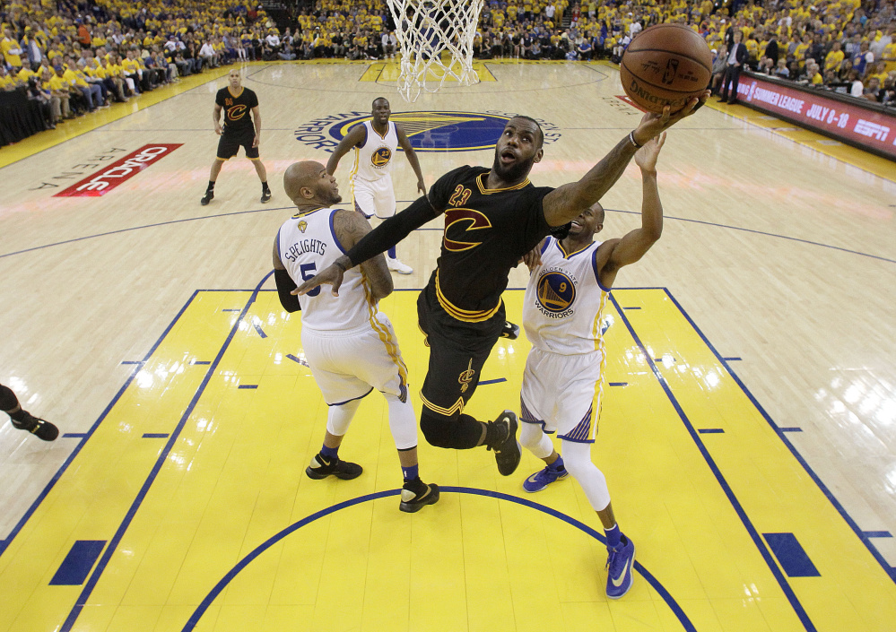 Cavaliers forward LeBron James takes a shot against Golden State during Cleveland's 93-89 win in Game 7 of the NBA finals on Sunday night in Oakland, California.