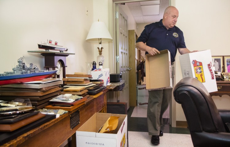 Outgoing Westbrook Superintendent of Schools Marc Gousse packs belongings from his office on Friday. He's changing jobs to become the superintendent of schools on Mount Desert Island, a smaller district with a higher salary, starting in July.