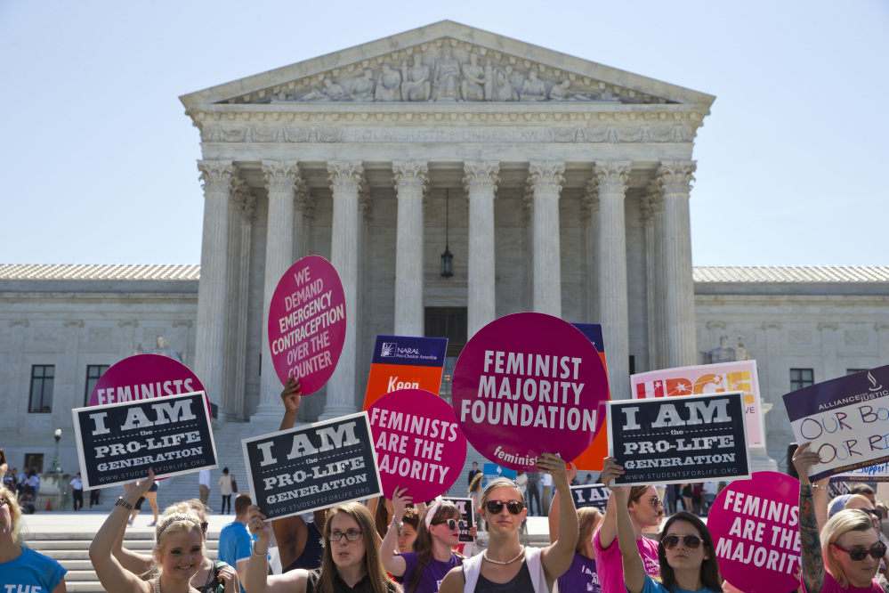 Demonstrators on both sides of the abortion issue stand in front of the Supreme Court in Washington, Monday, June 20, 2016, as the court announced several decisions. 