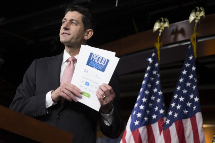 House Speaker Paul Ryan of Wisconsin holds up a fundraising form for House Democrats as he comments on the ongoing sit-in Thursday during a news conference on Capitol Hill in Washington.