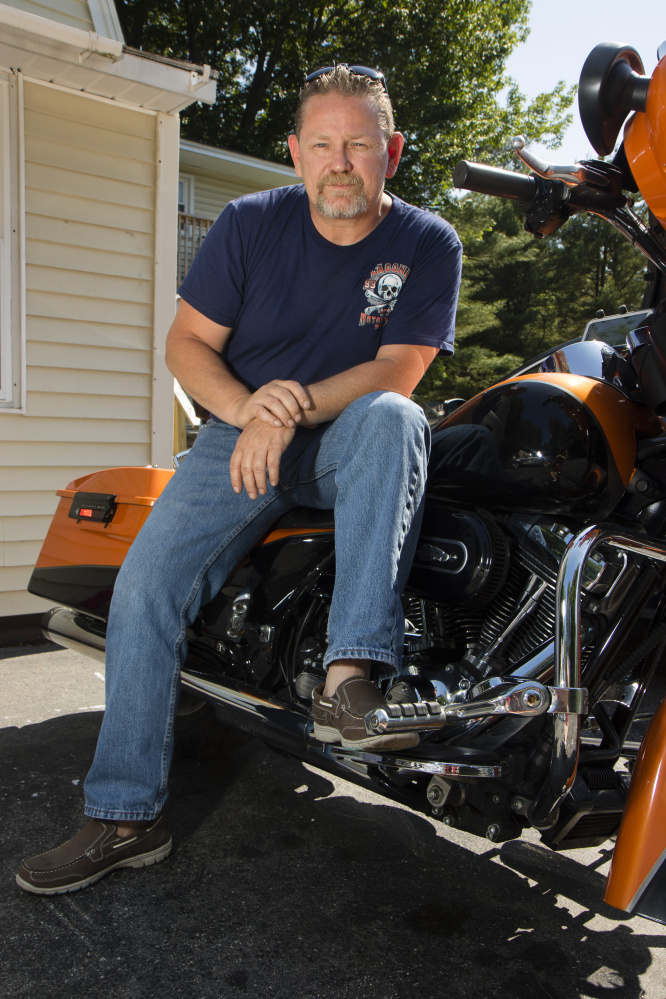 Chuck Phillips, 49 sits on his motorcycle outside his house in Saco on Friday. He says he'll vote for Trump, but also has issues with the Republican. "I'm not overly crazy about him but I find him the more palatable candidate."