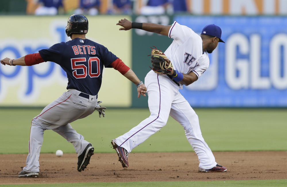 Boston's Mookie Betts steals second base as Rangers shortstop Elvis Andrus misses the throwing during the Red Sox' 8-7 win Friday in Arlington, Texas.