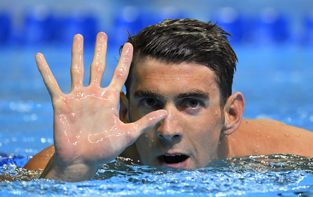 Michael Phelps gestures after winning the men's 200-meter butterfly at the U.S. Olympic swimming trials on Wednesday in Omaha, Neb. to secure his spot on a fifth Olympic team.