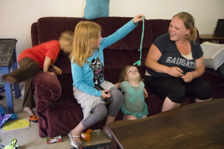 Sandra Vermette sits with her children in their apartment at Cranberry Ridge, a 16-unit subsidized complex in Sanford. "Unfortunately, I trusted her," she said of the baby sitter who overdosed while watching the kids. "You live and you learn."