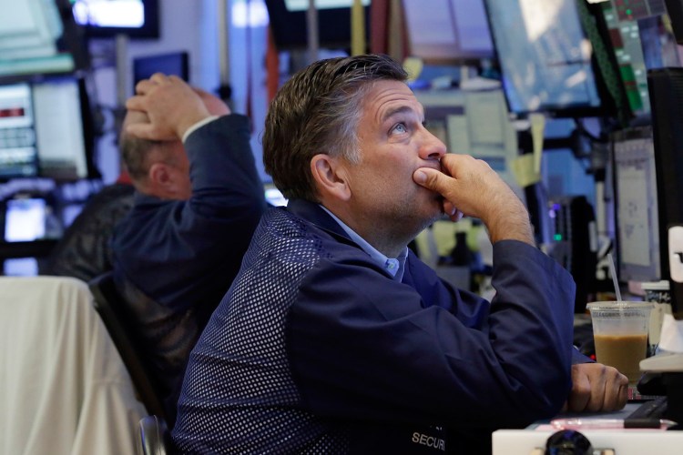 Trader Jeffrey Lucchesi works on the floor of the New York Stock Exchange Monday. Stocks are opening lower on Wall Street following bigger losses in Europe as investors continue to grapple with the fallout of Britain's vote to leave the European Union. 