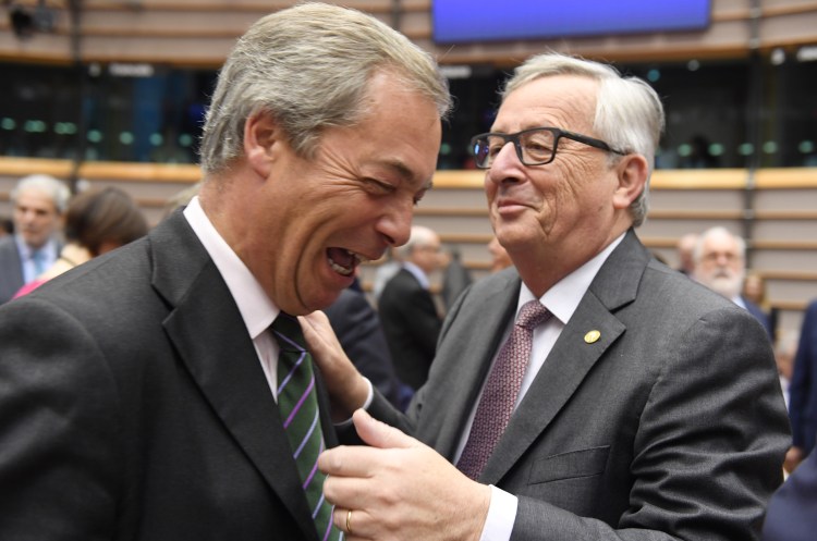 European Commission President Jean-Claude Juncker, right, greets UK Independent Party leader Nigel Farage during a special session of European Parliament in Brussels on Tuesday. EU heads of state and government are meeting Tuesday and Wednesday in Brussels for the first time since Britain voted to leave the European Union. Associated Press