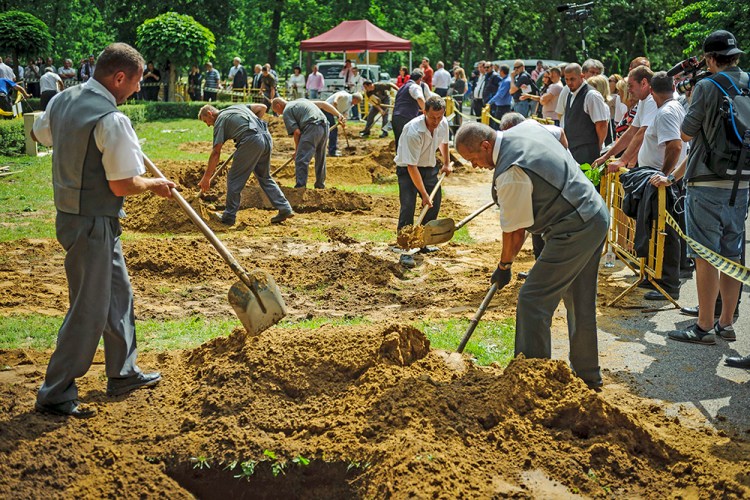 The first National Grave Digging competition takes place at the public cemetery of Debrecen, Hungary, Friday. Eighteen two-man teams are vying for a place in a regional championship to be held in Slovakia. Zsolt Czegledi/MTI via AP