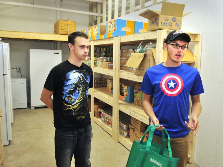 Kaleb Brann, left, and Jacob McKechnie talk about the new food bank program Thursday at the Augusta Boys and Girls Club in the Buker Community Center in Augusta.