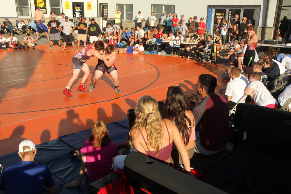 Skowhegan Area High School's Caleb Vautier, right, battles Nebraska's Cyrus Marshall during the 35th annual Maine-Nebraska wrestling exchange held Saturday in the Hight Chevrolet parking lot in downtown Skowhegan.