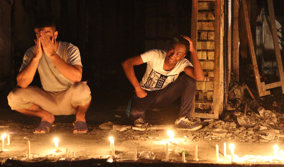 People light candles at the scene of a massive car bomb attack in Baghdad on Sunday.