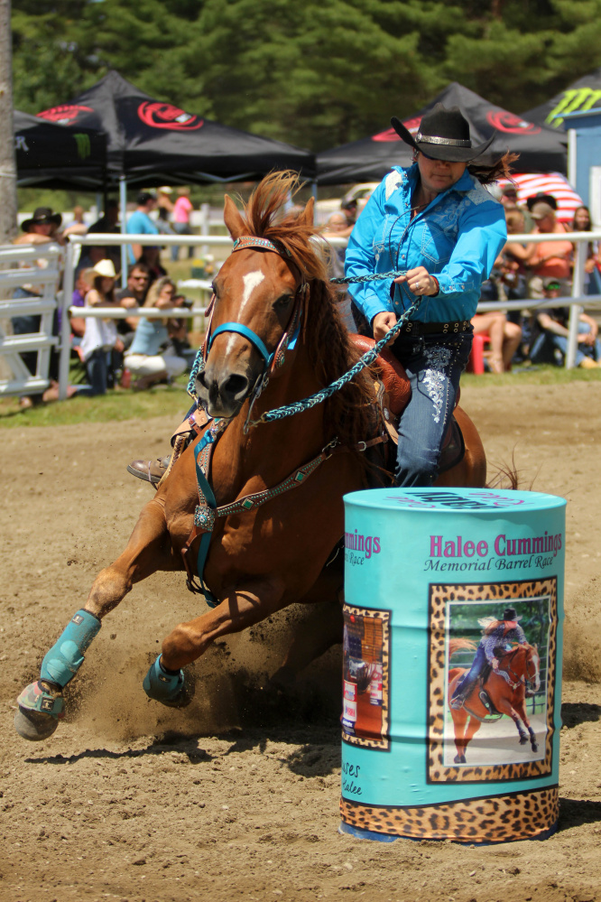 Tammie Cyr, of Hermon, rides her horse Roan Hopper at the Halee Lyn Cummings Memorial Barrel Race at the Silver Spur Riding Club in Sidney on Sunday. Halee Cummings, 18, of Sidney, died in an ATV accident last year.