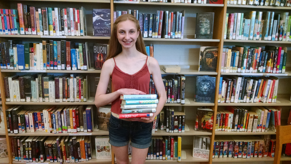 Miranda Sullivan holds a stack of books she has borrowed for the summer. The Messalonskee High School Library in Oakland is open for the summer between 10 a.m. and 2 p.m. Wednesdays. Students can borrow books and return them when school resumes in the fall. For more information, contact the high school at 465-7381.