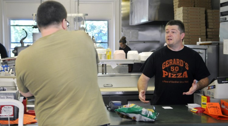 Gerard's Pizza proprietor Jeff McCormick speaks with customer Ben Tracy, of Gardiner, August 10, 2015, at the counter of the Gardiner restaurant. A fundraiser will be held Saturday to benefit McCormick, who is battling cancer.