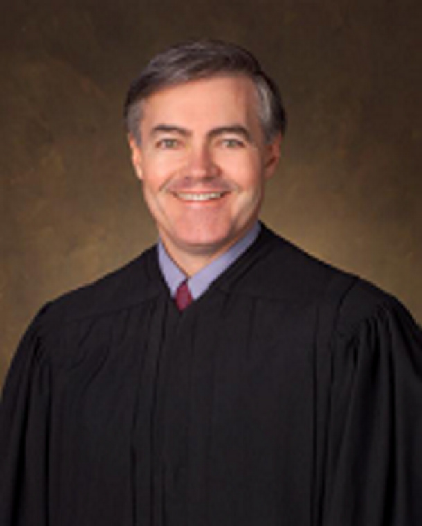 U.S. District Court Judge John A. Woodcock Jr. is moving to senior status, which will create a vacancy on the federal bench in Maine, the court announced Thursday.