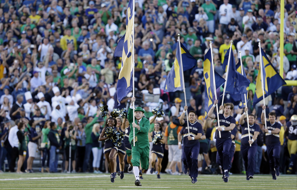 In this Sept. 6, 2014, file photo, the Notre Dame Leprechaun mascot takes the field before a game against Michigan in South Bend, Indiana. The two schools have reportedly agreed to resume their football rivalry.