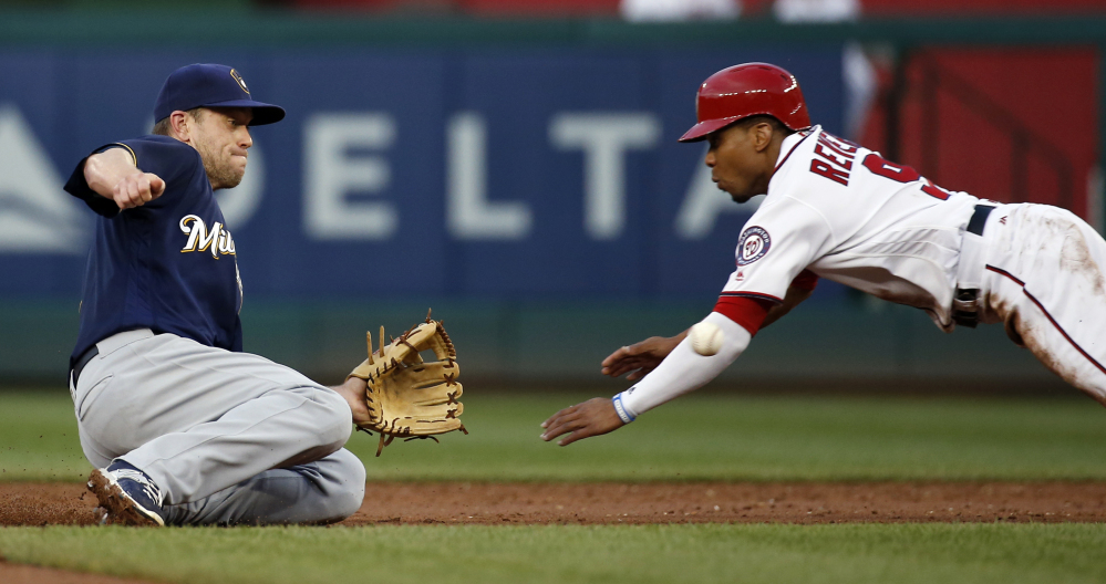 Milwaukee second baseman Aaron Hill waits for the throw from catcher Jonathan Lucroy and makes the tag for the out on Washington runner Ben Revere during the third inning Tuesday in Washington. The Red Sox acquired Hill on Thursday.