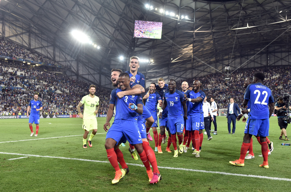 France players celebrate with the supporters at the end of the Euro 2016 semifinal against Germany at the Velodrome stadium in Marseille, France on Thursday.