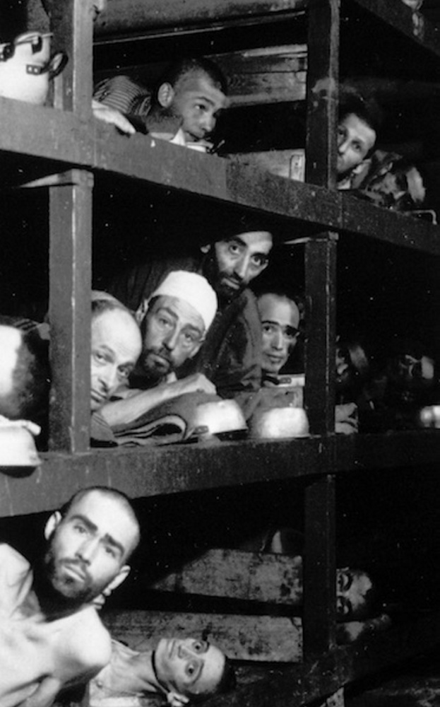 This April 16, 1945 file photo provided by the U.S. Army, shows inmates of the German KZ Buchenwald inside their barrack, a few days after U.S troops liberated this concentration camp near Weimar. The young man fourth from left in the middle row bunk is Elie Wiesel, who would later become an author and Nobel Peace Prize laureate.