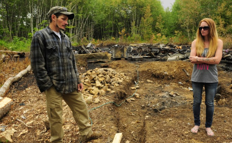 Eric and Kristie Baker talk on Thursday about a cabin they plan to build at the fire scene in Gardiner, where their travel trailer was destroyed on Blueberry Hill Lane.