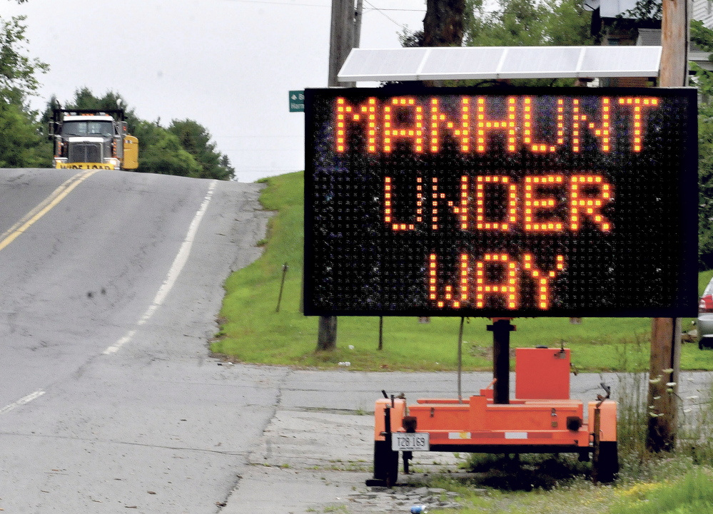 A trucker comes down Route 150 into the town of Athens in July 2015 near a large sign advising people of the manhunt for murder suspect Robert Burton. Burton was on the run for nine weeks before he turned himself in at the Piscataquis County Sheriff's Office in August. His trial begins with jury selection Aug. 22 in Penobscot County Superior Court in Bangor, where it was moved because of pre-trial publicity.