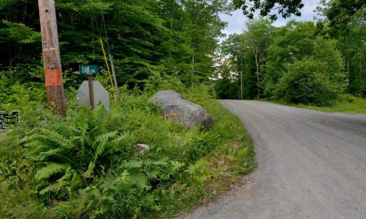 The entrance to Tuttle Cemetery in Rome is on Oak Ridge, seen here Tuesday, a road that is owned by Peter Fotter. The town of Rome alleges Fotter is blocking access to the cemetery even though the town has a right of way and Fotter has a responsibility to maintain the entrance.